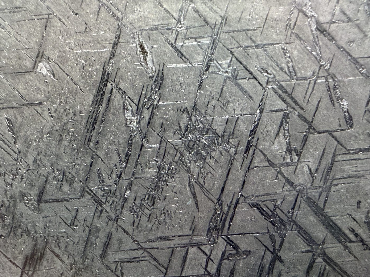 Macro view of the etched crossing line pattern in Gyarub Zangbo pallasite metal, 324.46g