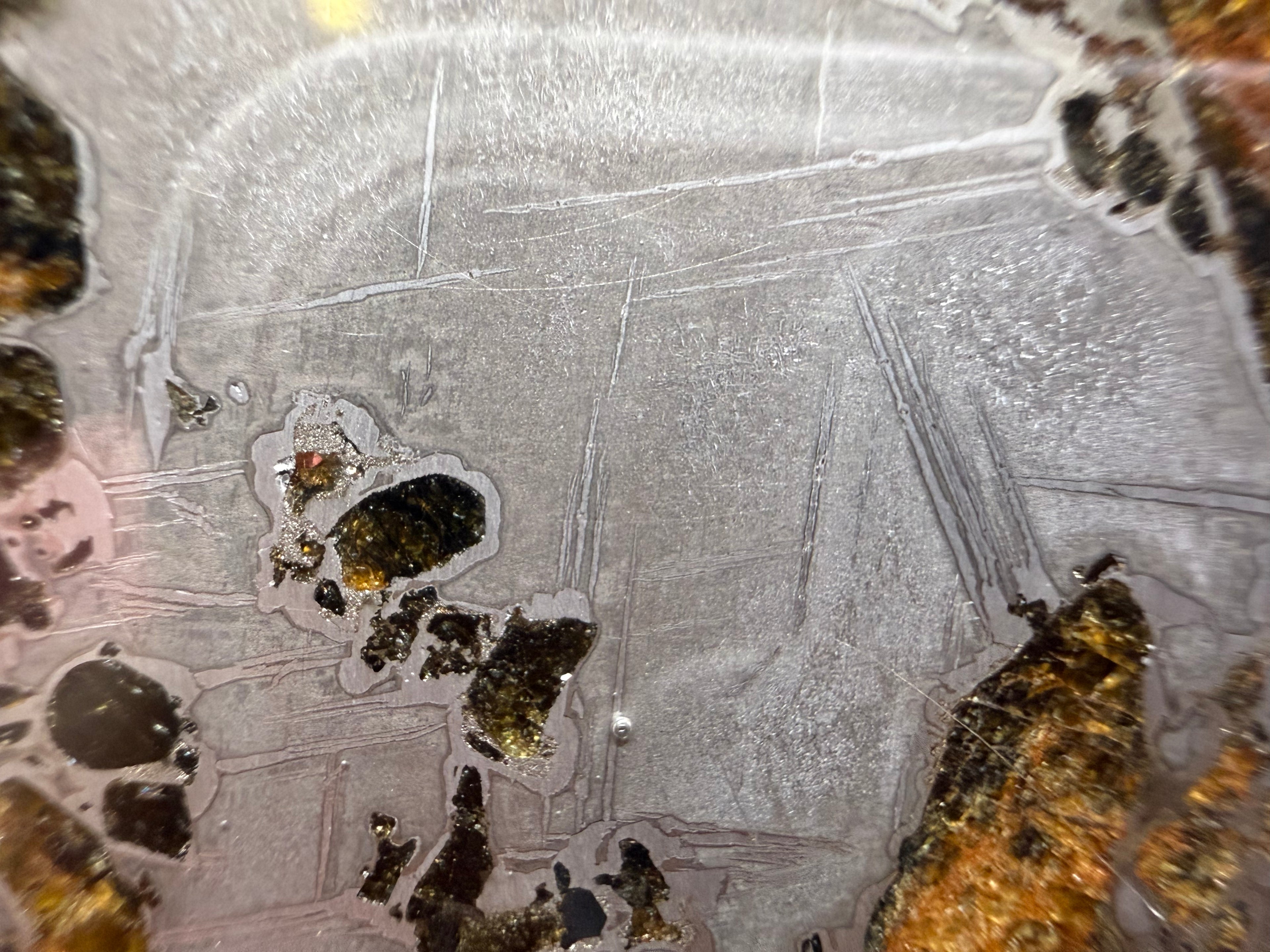 Macro detail, Gyarub Zangbo Ungrouped Pallasite, kamacite surface with Widmanstatten etching pattern emerging across iron-nickel metal, 76.62g