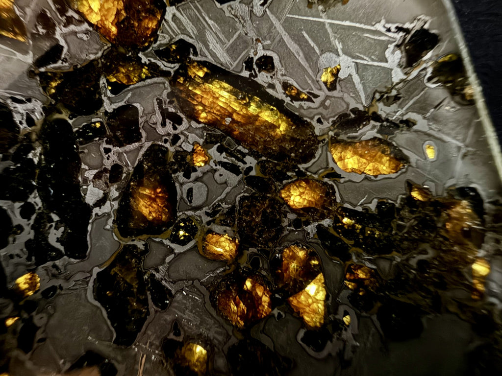Macro of etched metal between olivine crystals in the Gyarub Zangbo pallasite, 84.69g, showing the crosshatched kamacite and taenite pattern
