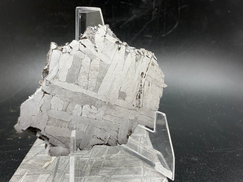 Kaalijärv iron meteorite 31.18g full slice on acrylic display stand side view showing slice thickness and natural edge profile
