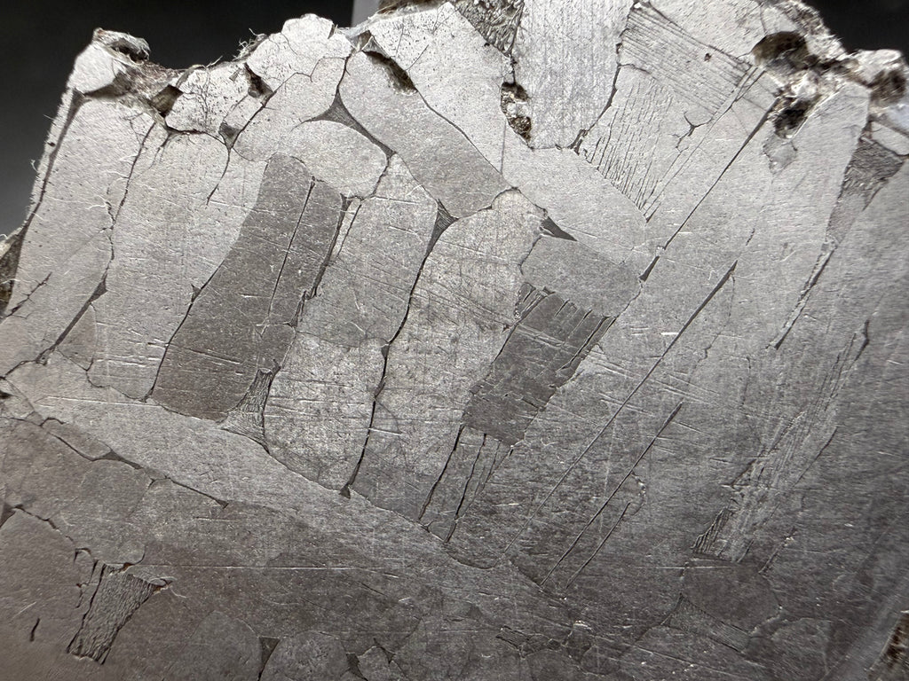 Kaalijärv iron meteorite 31.18g full slice close-up of etched face showing band detail within kamacite lamellae and taenite borders on left side