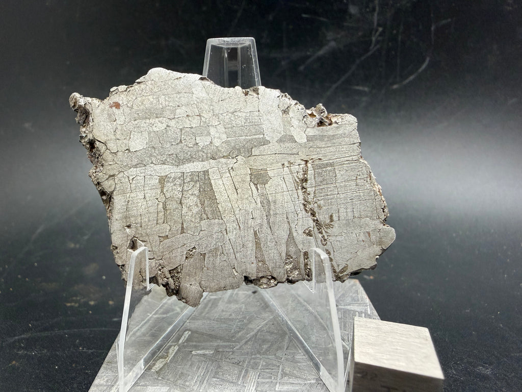 Kaalijärv iron meteorite 33.00g full slice on acrylic display stand top-down view of reverse side showing weathered crust and etched face