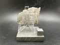 Kaalijärv iron meteorite 33.00g full slice on acrylic display stand front view showing Widmanstätten pattern weathered natural edge and titanium cube for scale