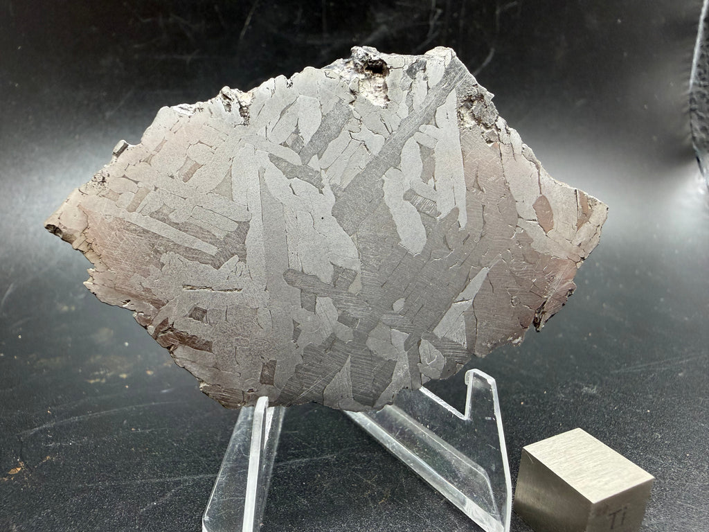 Kaalijärv iron meteorite 45.71g full slice on acrylic display stand angled view showing etched face and natural edge