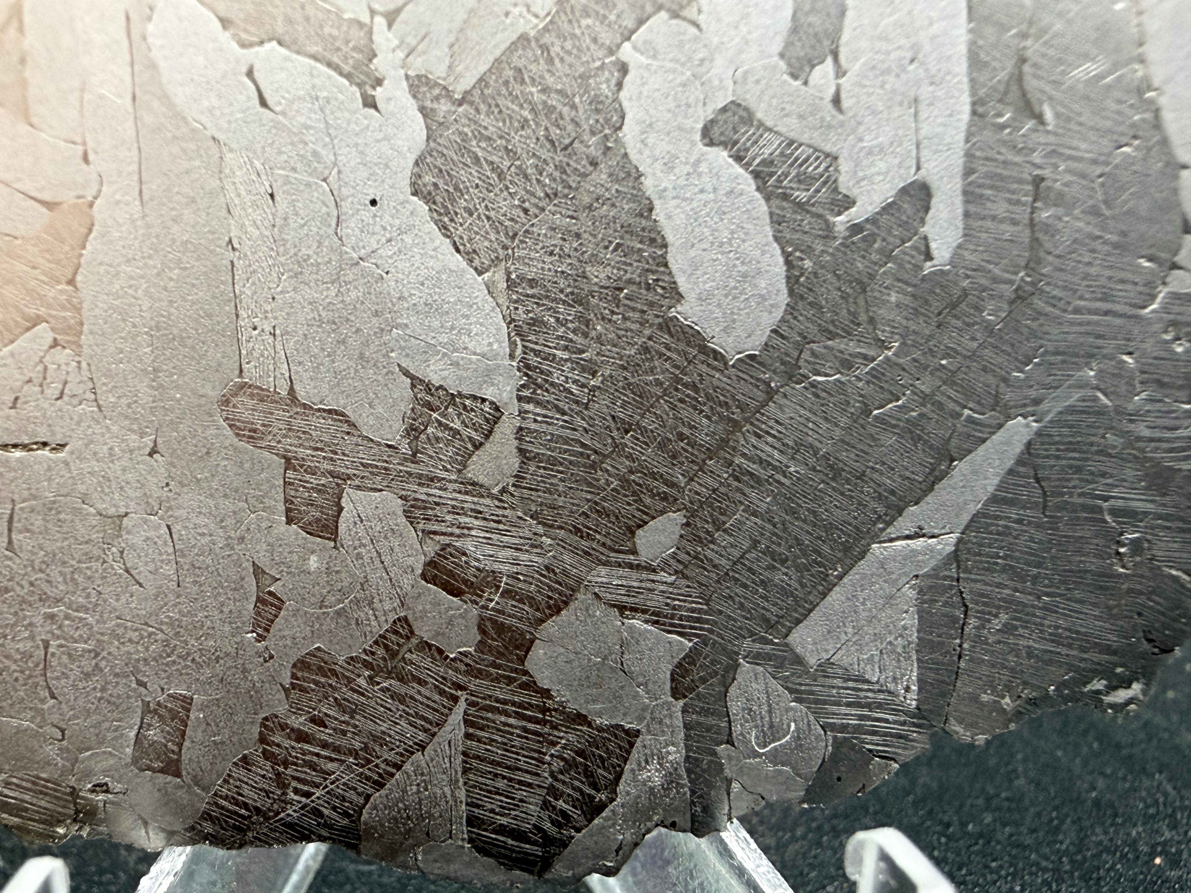 Kaalijärv iron meteorite 45.71g full slice macro detail of Neumann bands within kamacite lamellae on lower portion