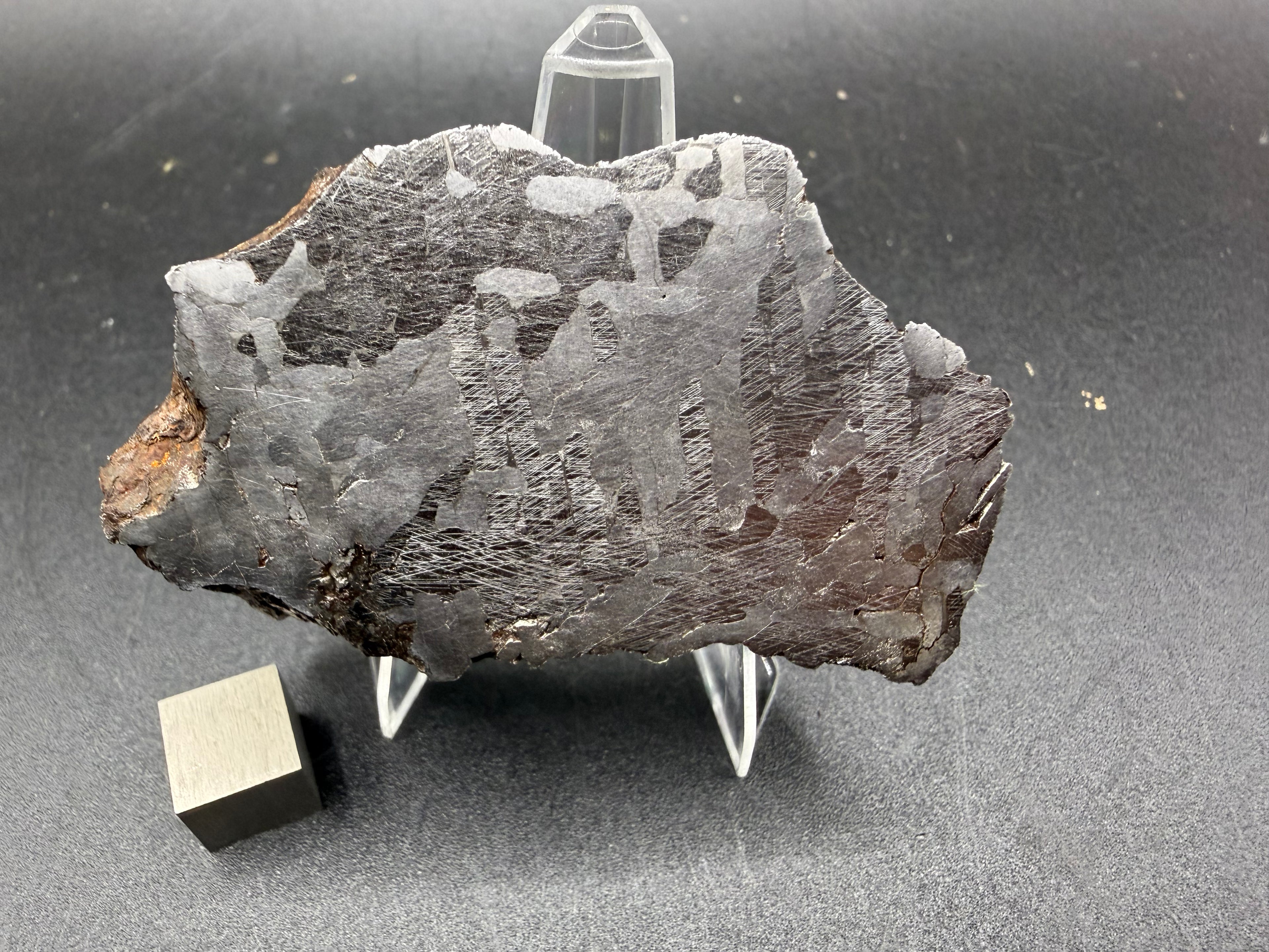 Kaalijarv iron meteorite, IAB-MG, 127.37 g end cut standing upright, full view of the etched cut face with brown weathered exterior along the left edge
