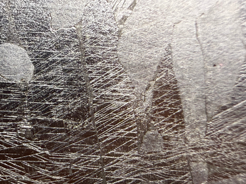 Kaalijarv iron meteorite, IAB-MG, 127.37 g end cut, close-up of the etched cut face showing several intersecting sets of fine straight Neumann bands