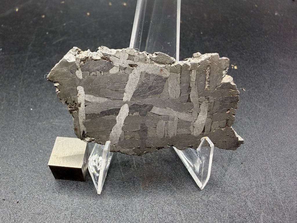 Kaalijarv iron meteorite, IAB-MG, 22.00 g slice standing upright, full etched face with bright kamacite plates crossing at angles over darker gray areas