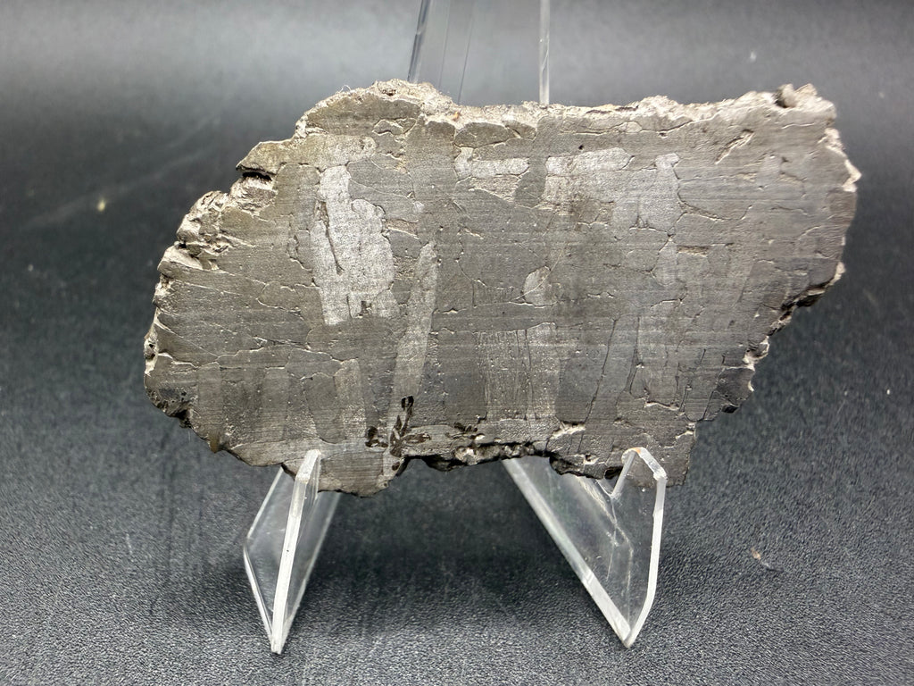 Kaalijarv iron meteorite, IAB-MG, 28.43 g slice standing upright, second face with a fainter etched pattern of lighter kamacite plates