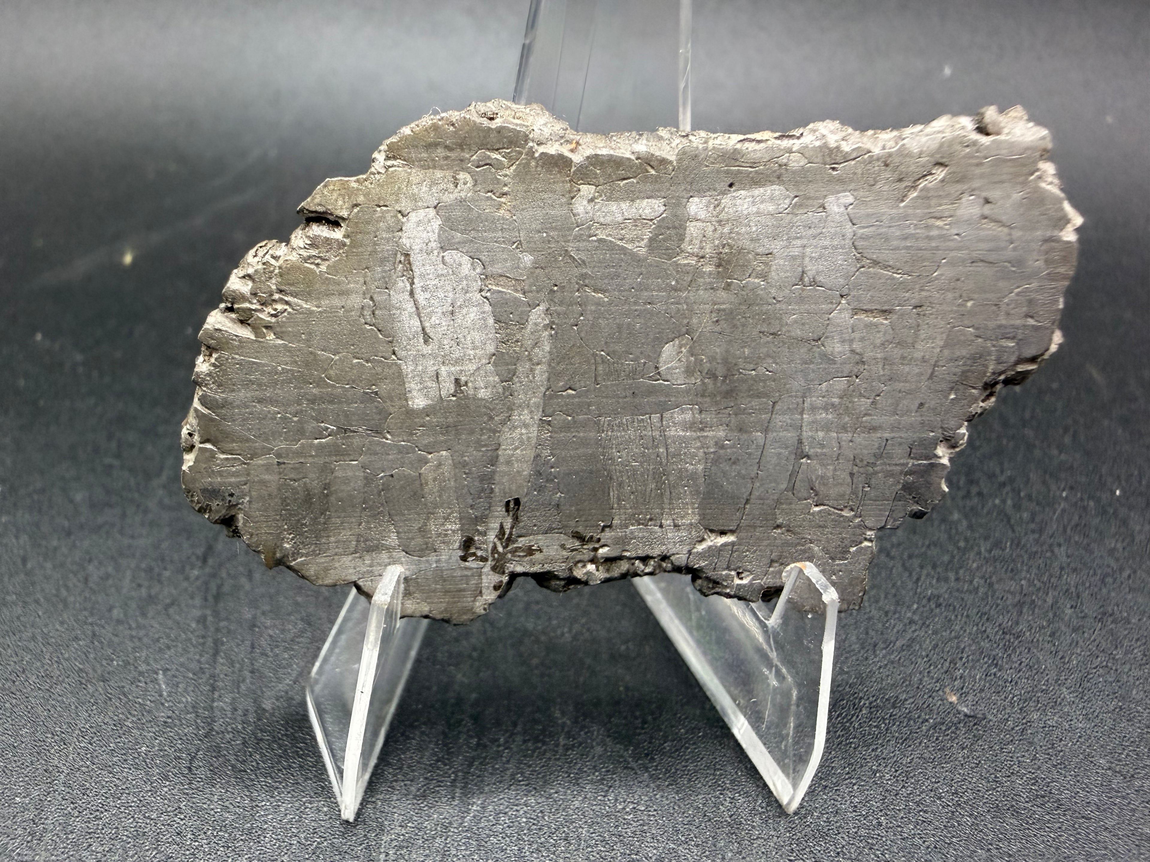 Kaalijarv iron meteorite, IAB-MG, 28.43 g slice standing upright, second face with a fainter etched pattern of lighter kamacite plates