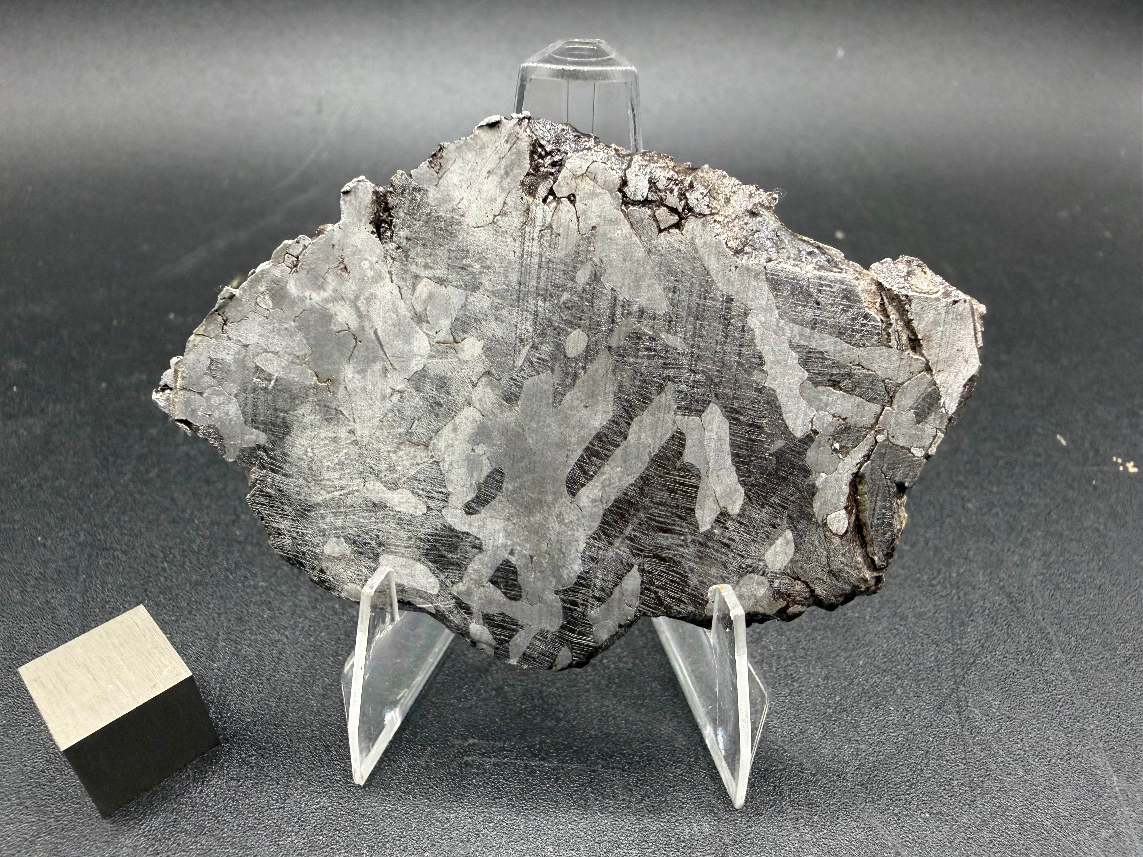 Kaalijarv iron meteorite, IAB-MG, 33.88 g slice standing upright, second etched face with lighter kamacite plates and darker zones crossed by Neumann bands