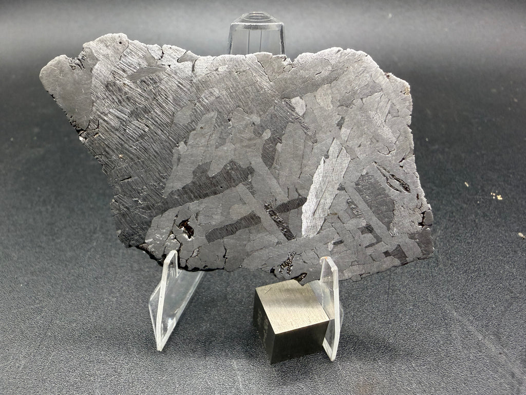 Kaalijarv iron meteorite, IAB-MG, 39.28 g slice standing upright, full etched face with crossing kamacite plates and broad zones of Neumann bands