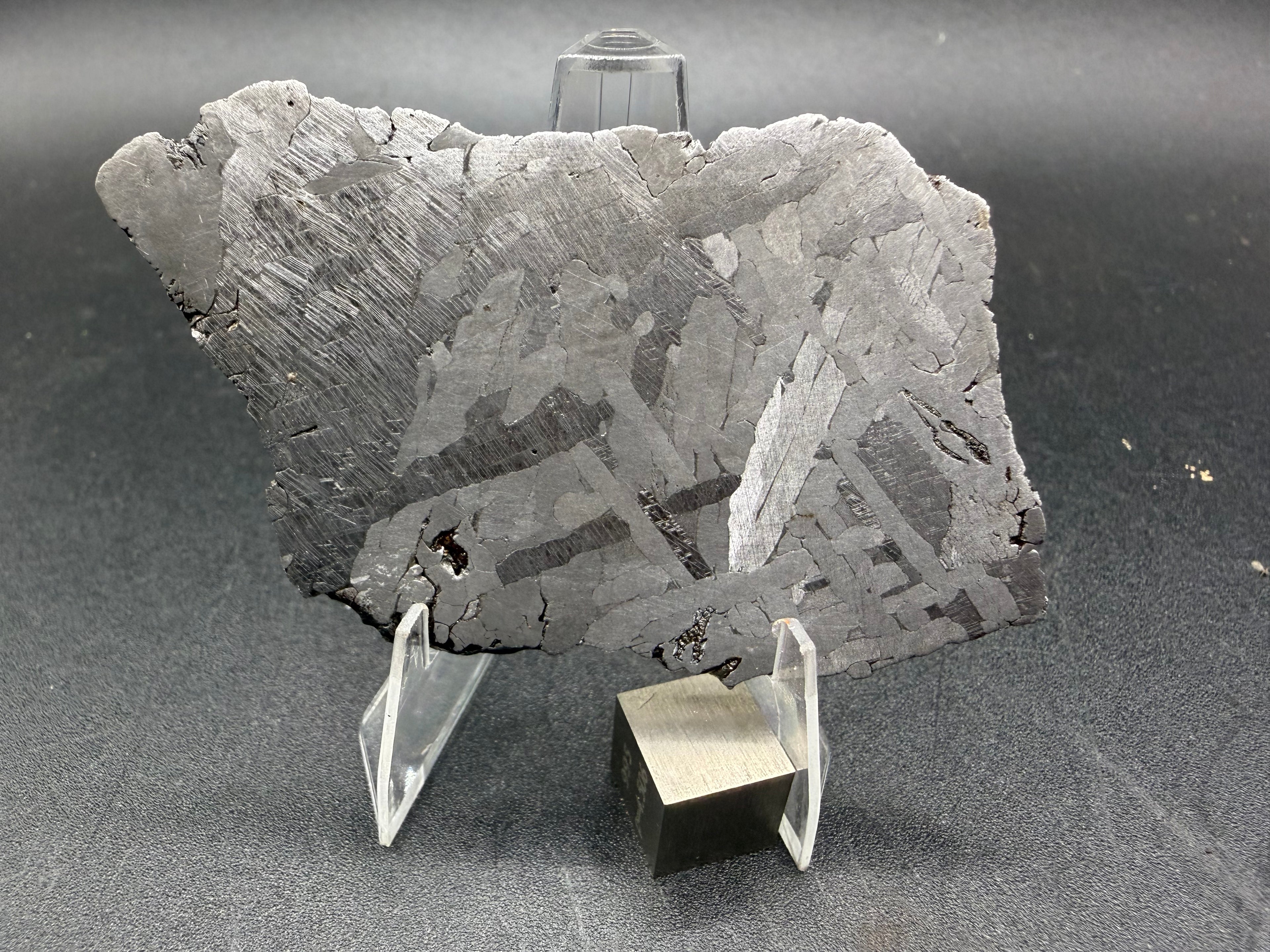 Kaalijarv iron meteorite, IAB-MG, 39.28 g slice standing upright, full etched face with crossing kamacite plates and broad zones of Neumann bands