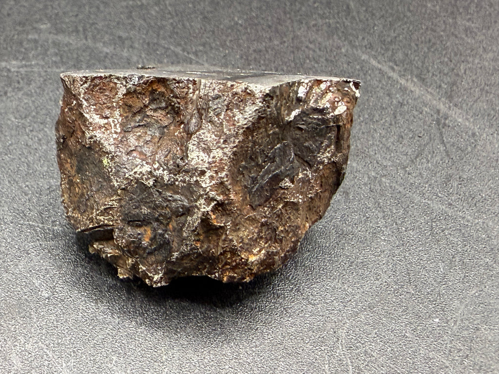 Kaalijarv iron meteorite, IAB-MG, 67.48 g end cut, natural weathered exterior with the flat cut face visible along the top edge