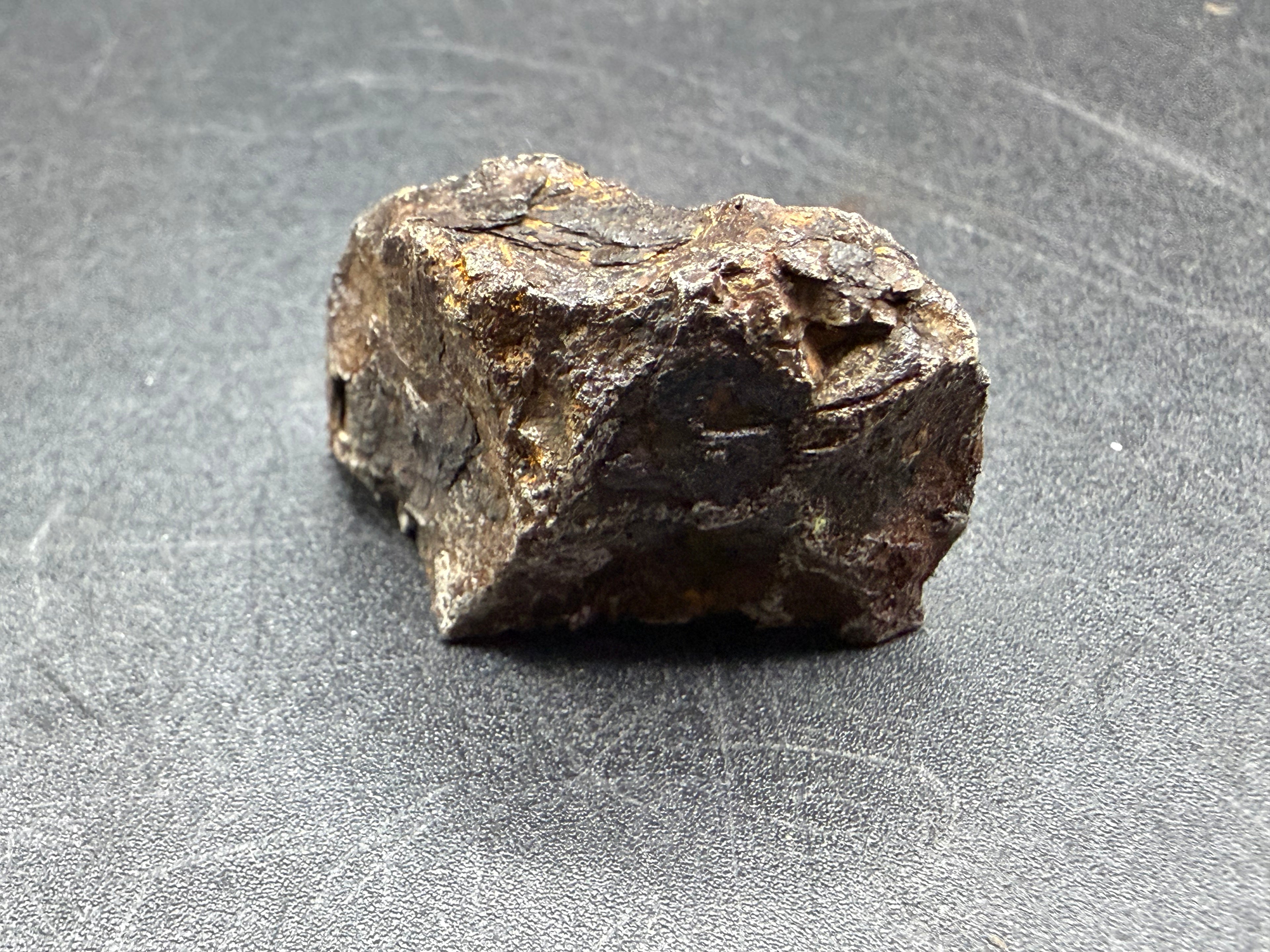 Kaalijarv iron meteorite, IAB-MG, 67.48 g end cut, natural weathered exterior seen from the side, brown and dark gray with a rough, uneven surface
