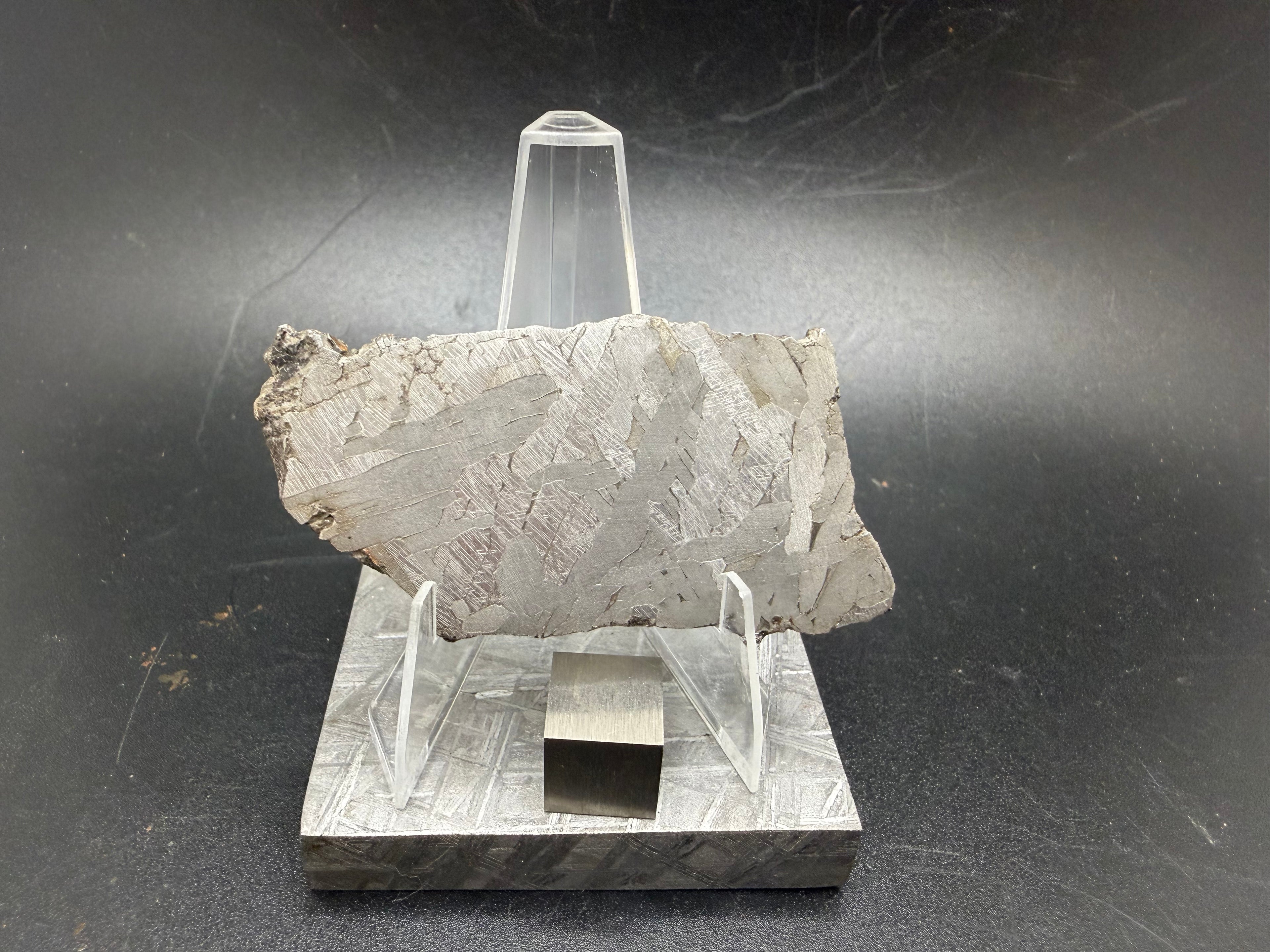 Kaali järv iron meteorite slice on display stand, front view