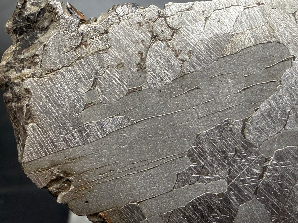 Kaalijärv iron meteorite cut face detail showing crystalline structure Neumann bands, Widmanstätten pattern and natural edge