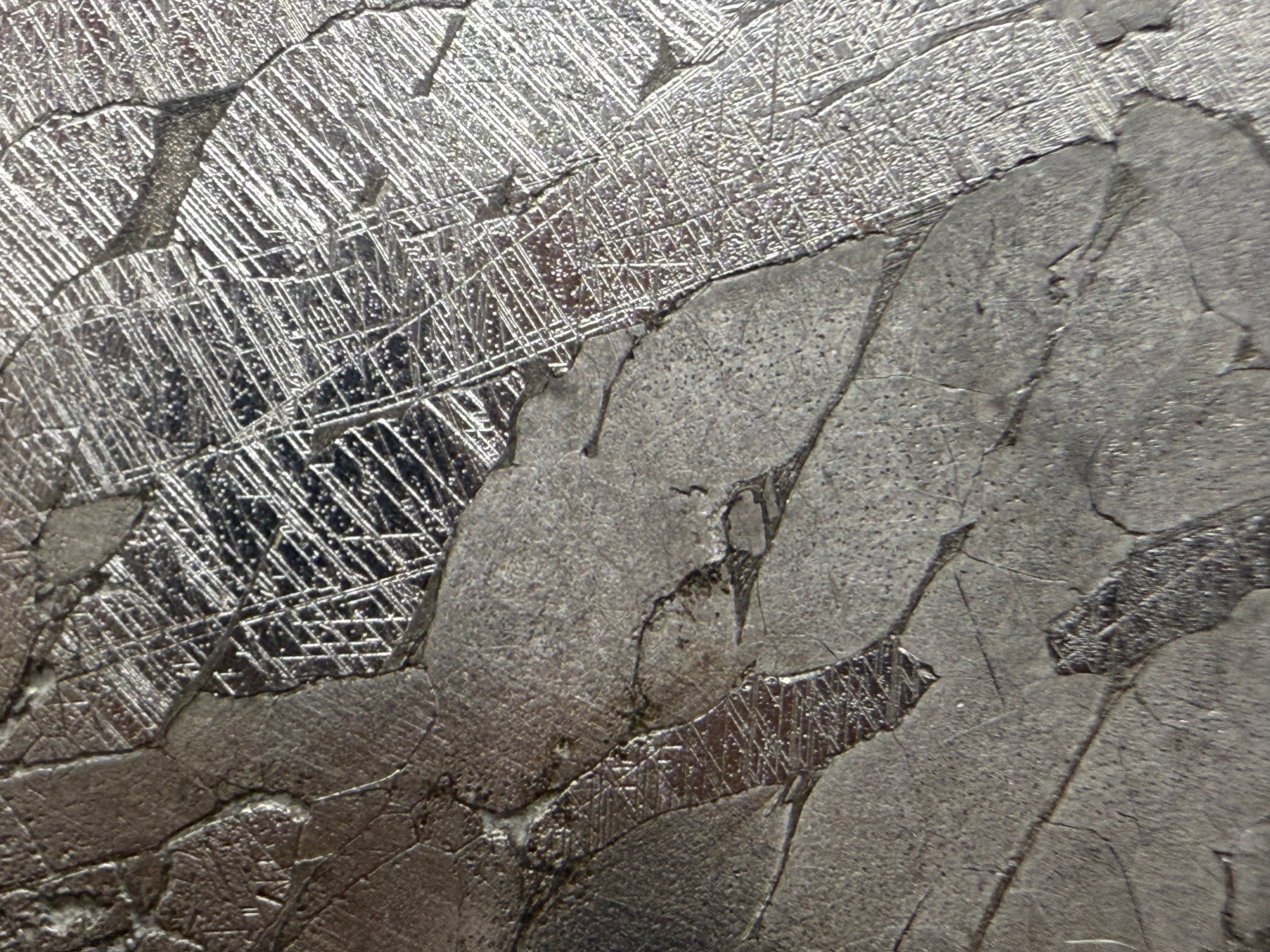 Macro detail of Neumann bands and kamacite crystal structure in Kaalijärv IAB-MG iron meteorite, 33.38g slice