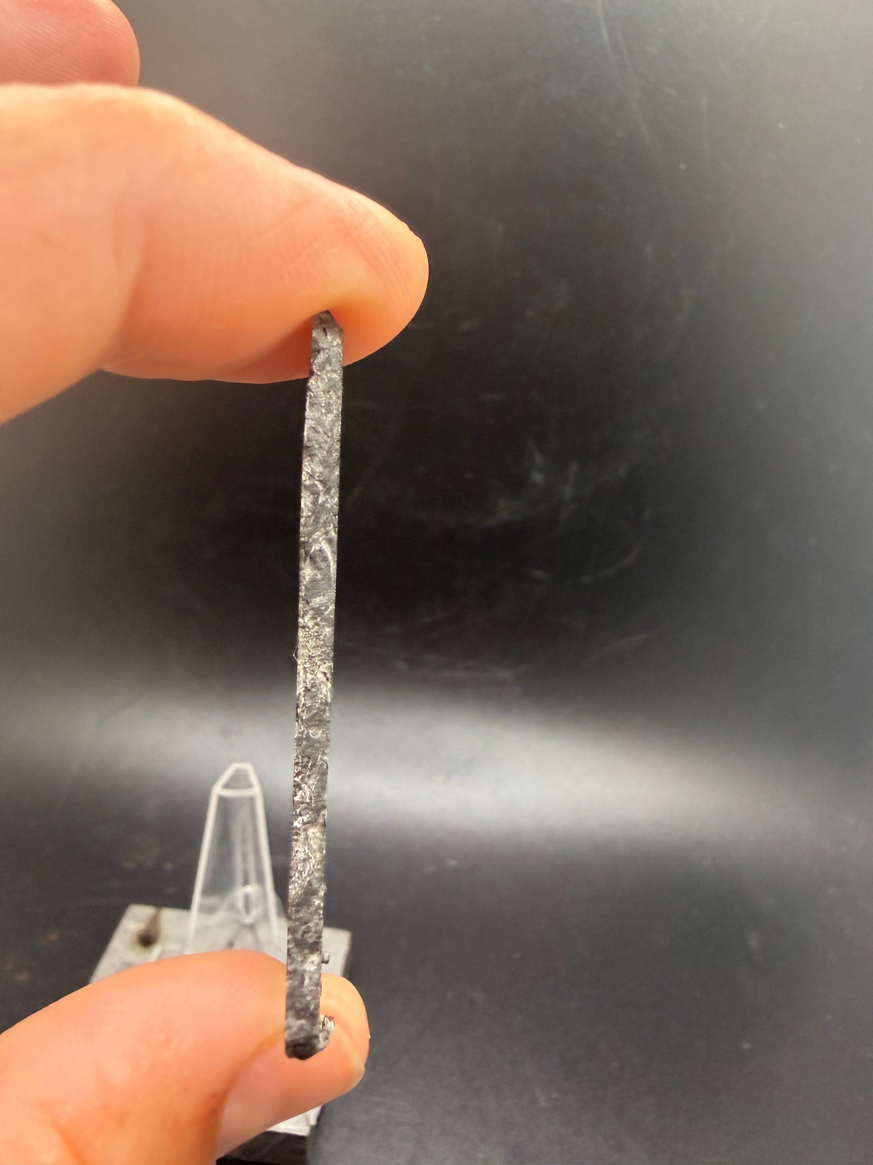 Natural edge and fusion crust remnant detail on Kaalijärv IAB-MG iron meteorite slice 33.38g