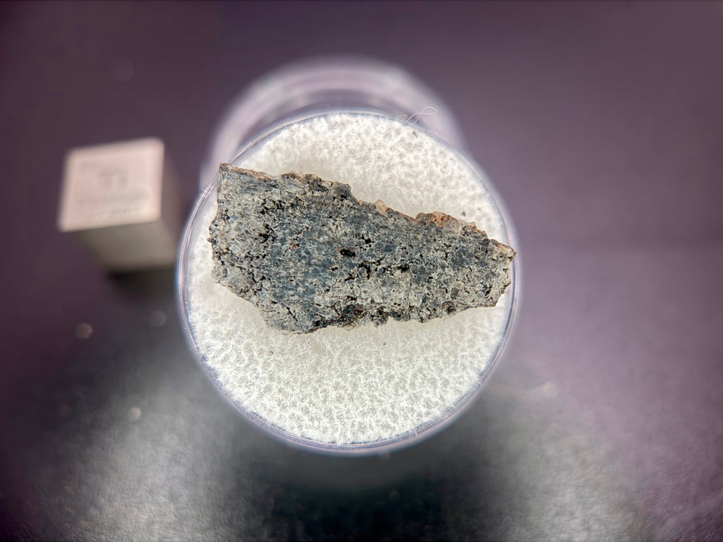 Top view of Ksar Ghilane 022 ungrouped achondrite meteorite slice showing differentiated igneous texture with accessory daubreelite and alabandite, 1.75g