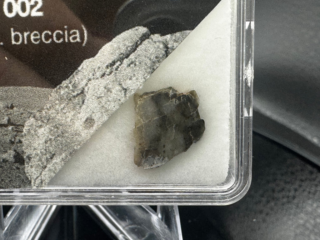 Laâyoune 002 lunar meteorite slice in small display box close-up
