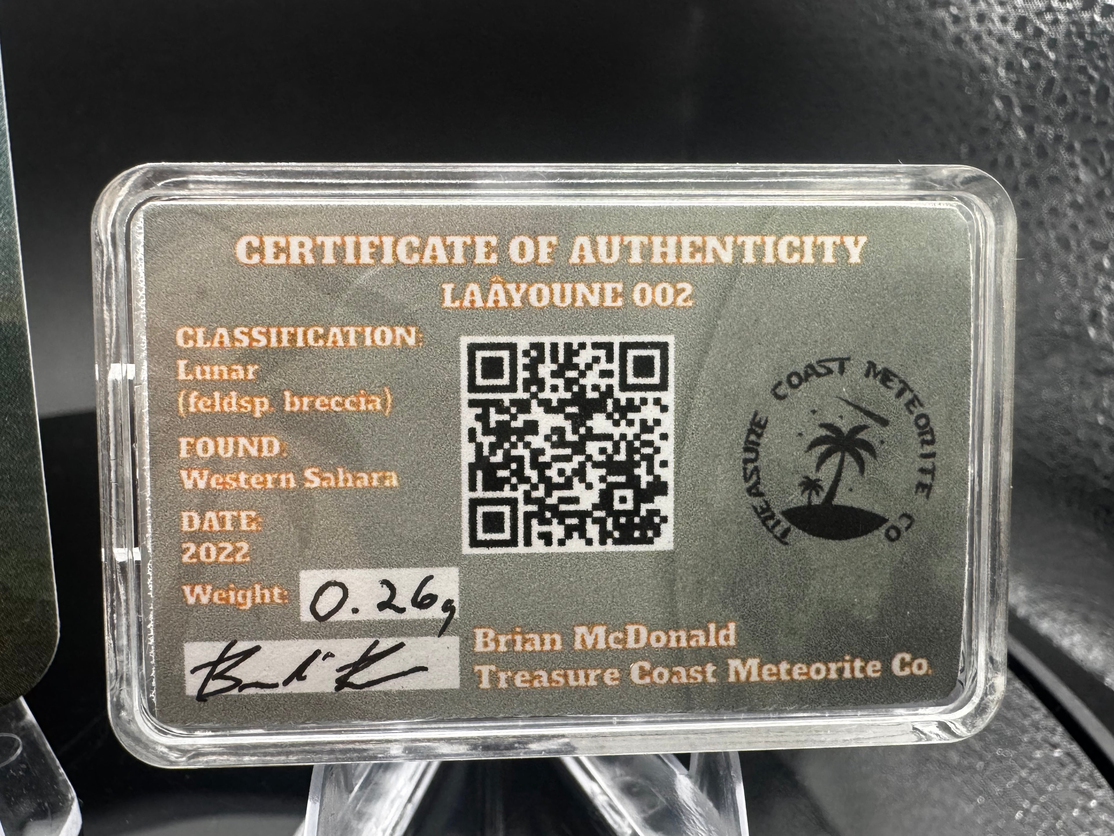 Laâyoune 002 lunar meteorite display case with specimen information card