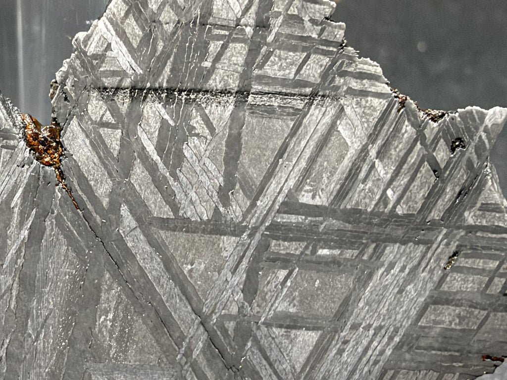 Detail of intersecting kamacite bands on the polished face of the 33.46g Muonionalusta slice