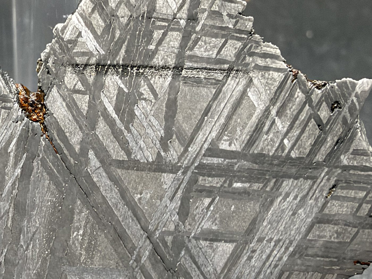 Detail of intersecting kamacite bands on the polished face of the 33.46g Muonionalusta slice