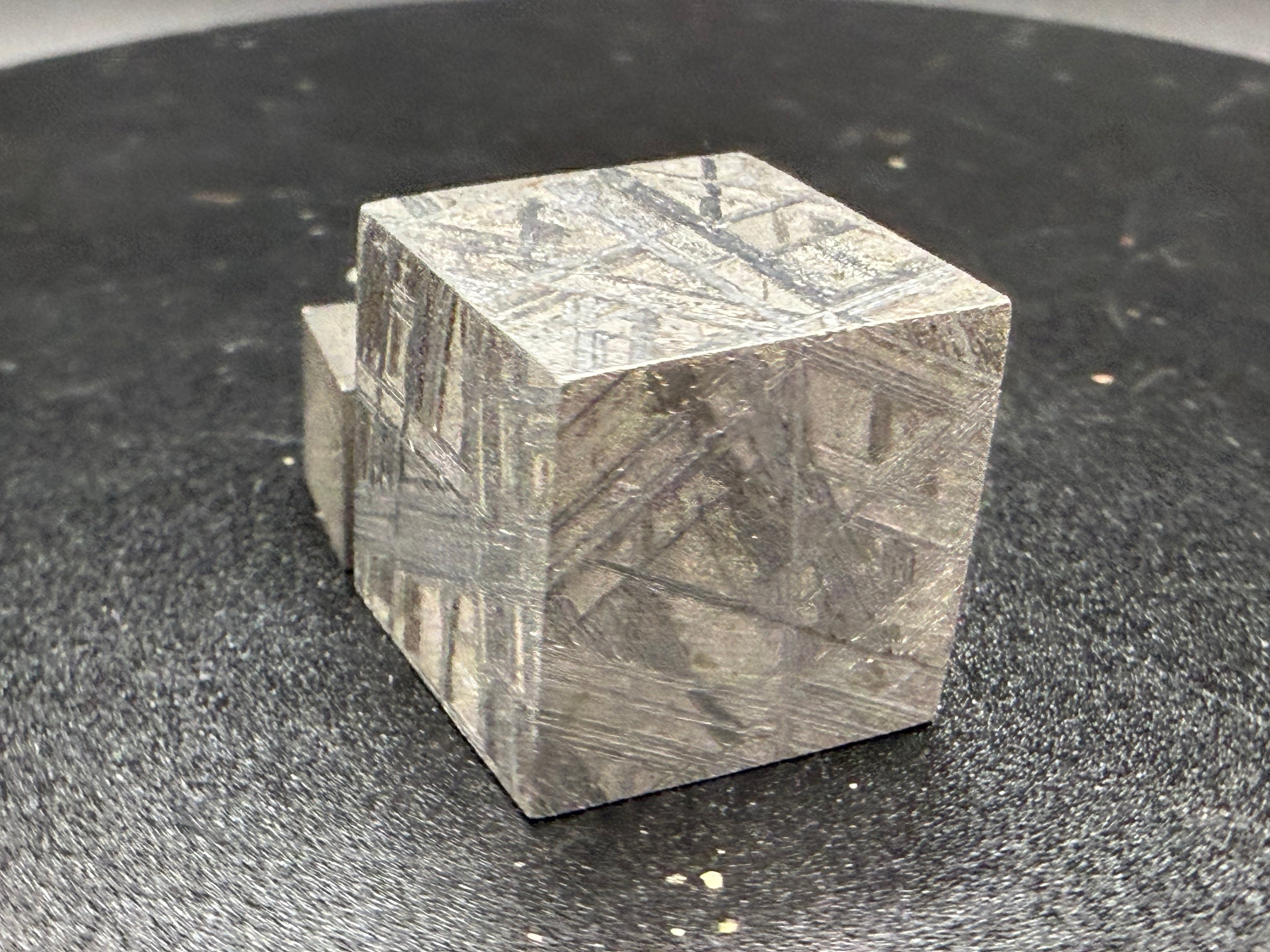Three quarter view of Muonionalusta iron meteorite 2cm cube showing etched Widmanstatten pattern on three faces, 65g