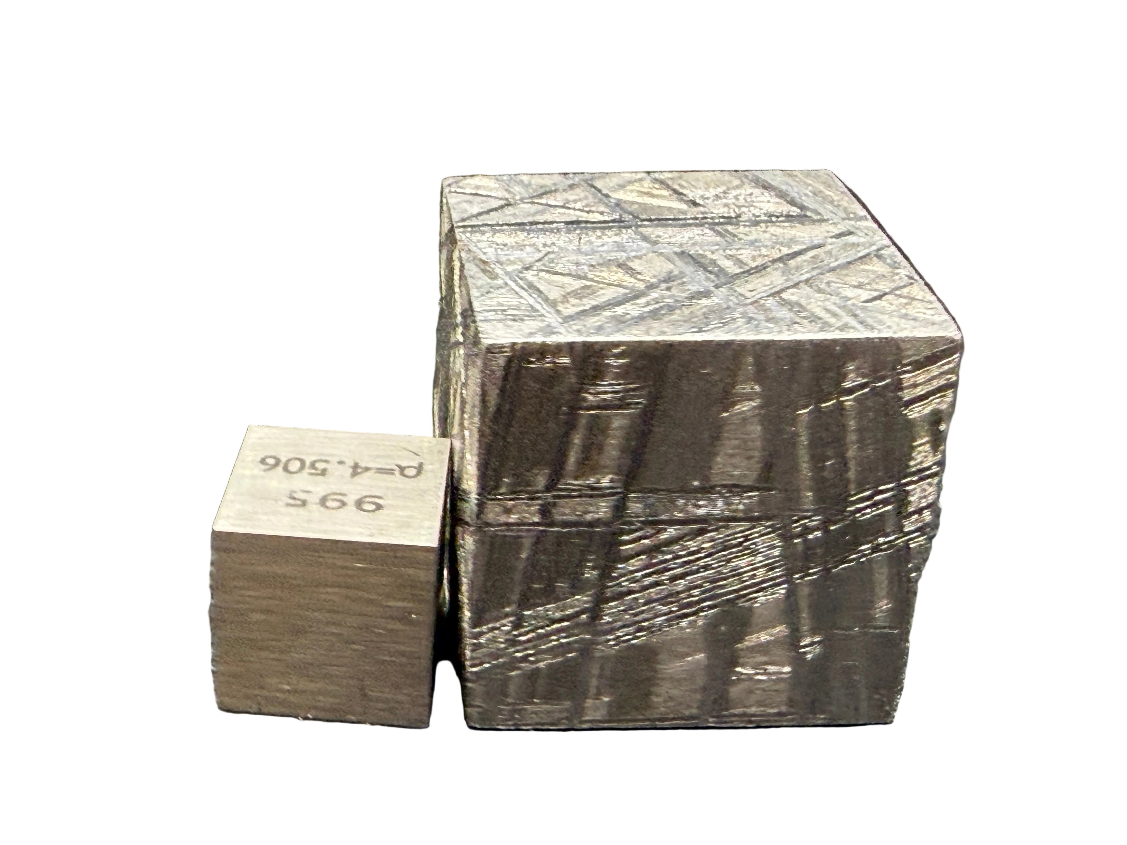 Side profile of Muonionalusta IVA fine octahedrite cube showing etched kamacite bands beside density reference cube, 65g