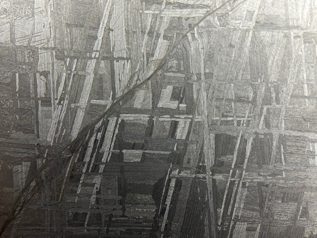 Muonionalusta slice 330.81g -- surface texture showing differential etching of metallic phases
