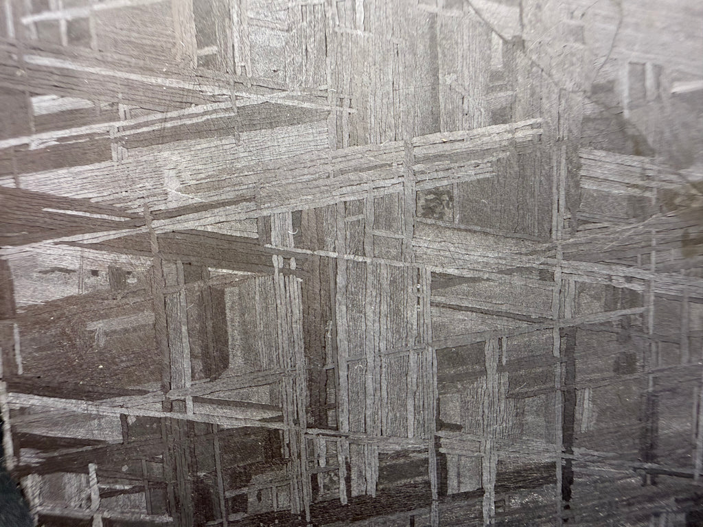 Muonionalusta meteorite close-up showing deformation vein cutting across Widmanstätten pattern in the iron structure.