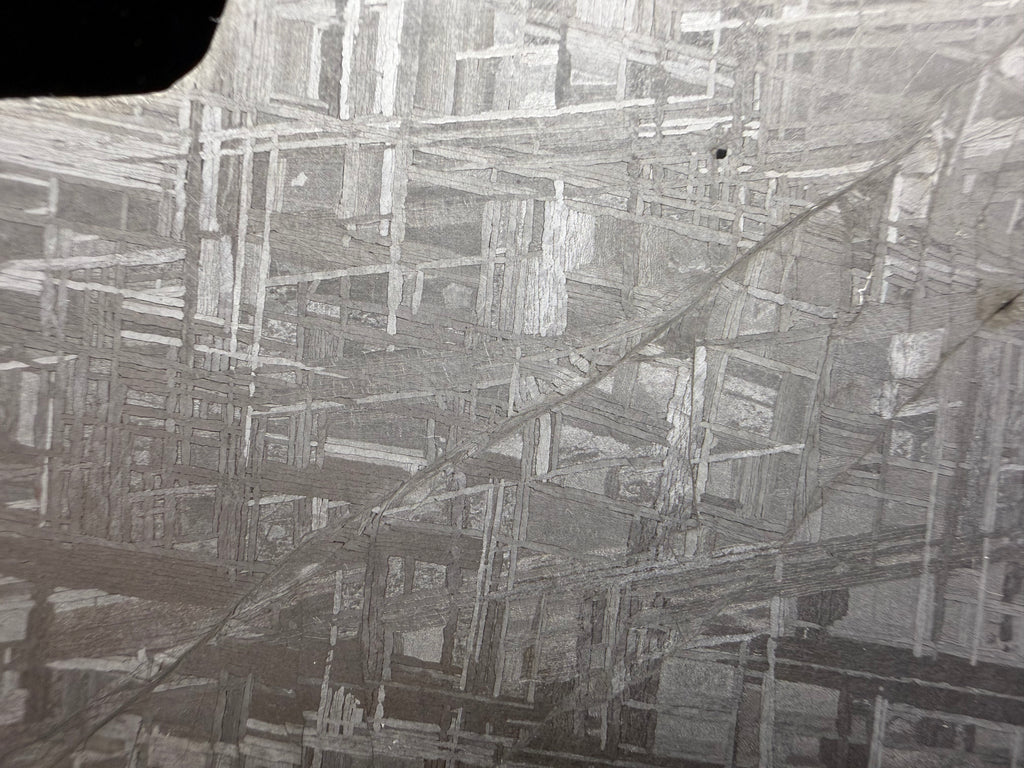 Close-up of etched Muonionalusta iron meteorite showing Widmanstätten pattern formed during slow cooling inside a planetary core.