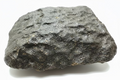 Profile view of NWA 17296 L5 Ordinary Chondrite Meteorite showing complete oriented stone with fusion-crusted dorsal surface and natural resting base, 1472.00g