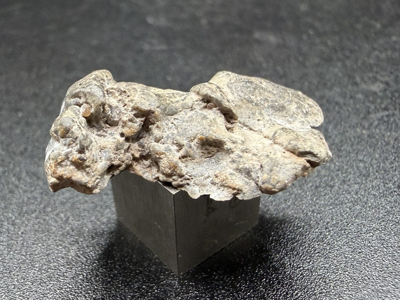 Reverse exterior view of NWA 17706 Lunar meteorite showing irregular weathered surface, 2.20g