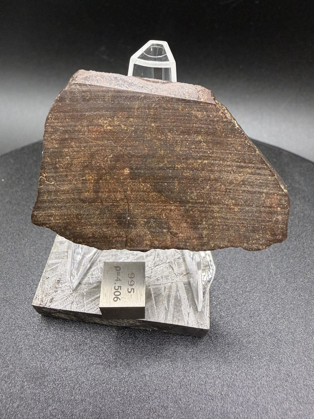 Reverse face of NWA 17916 CO3 carbonaceous chondrite meteorite slice showing saw cut surface with visible cutting striations, 11.28g