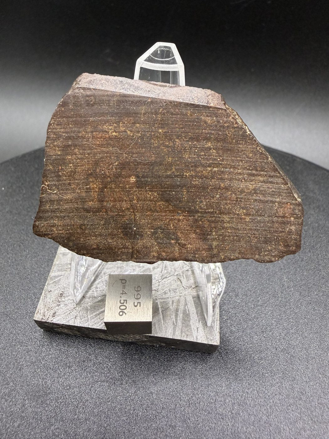 Reverse face of NWA 17916 CO3 carbonaceous chondrite meteorite slice showing saw cut surface with visible cutting striations, 11.28g