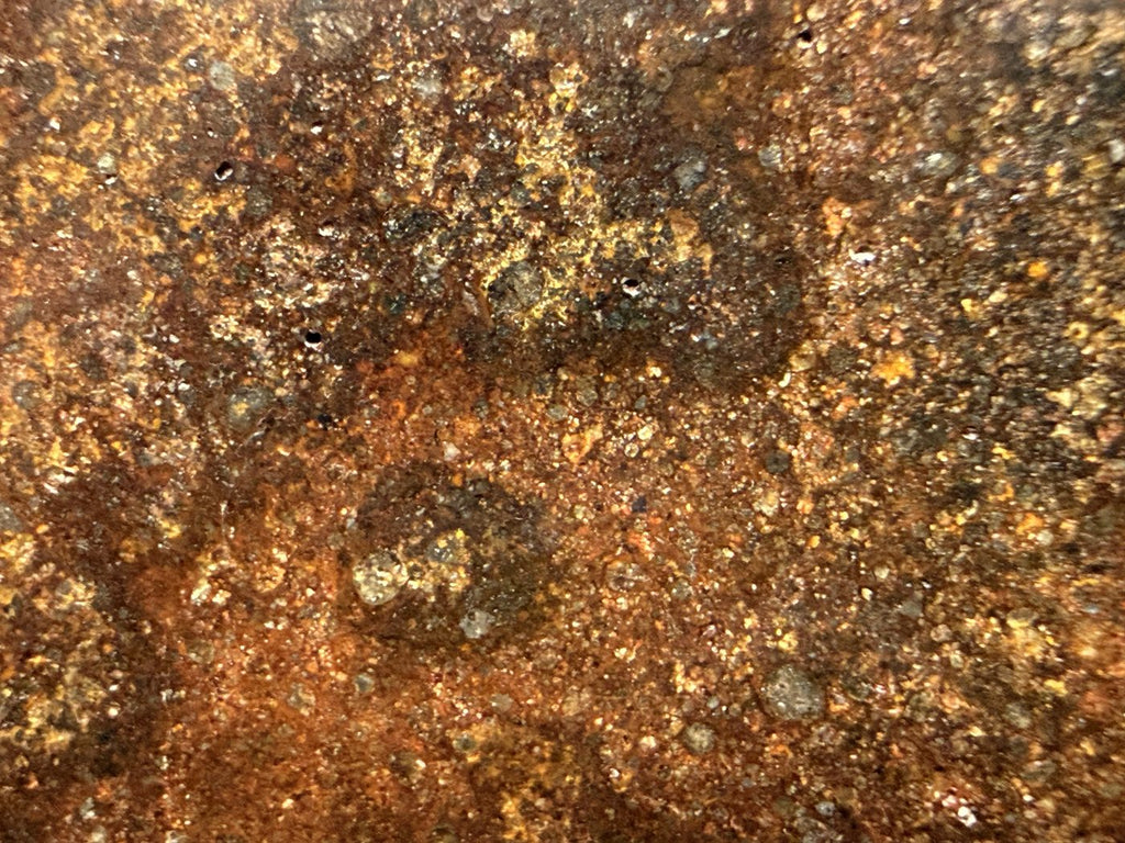 Macro view of NWA 17916 CO3 carbonaceous chondrite meteorite showing pale inclusions and chondrules across the polished face, 13.00g