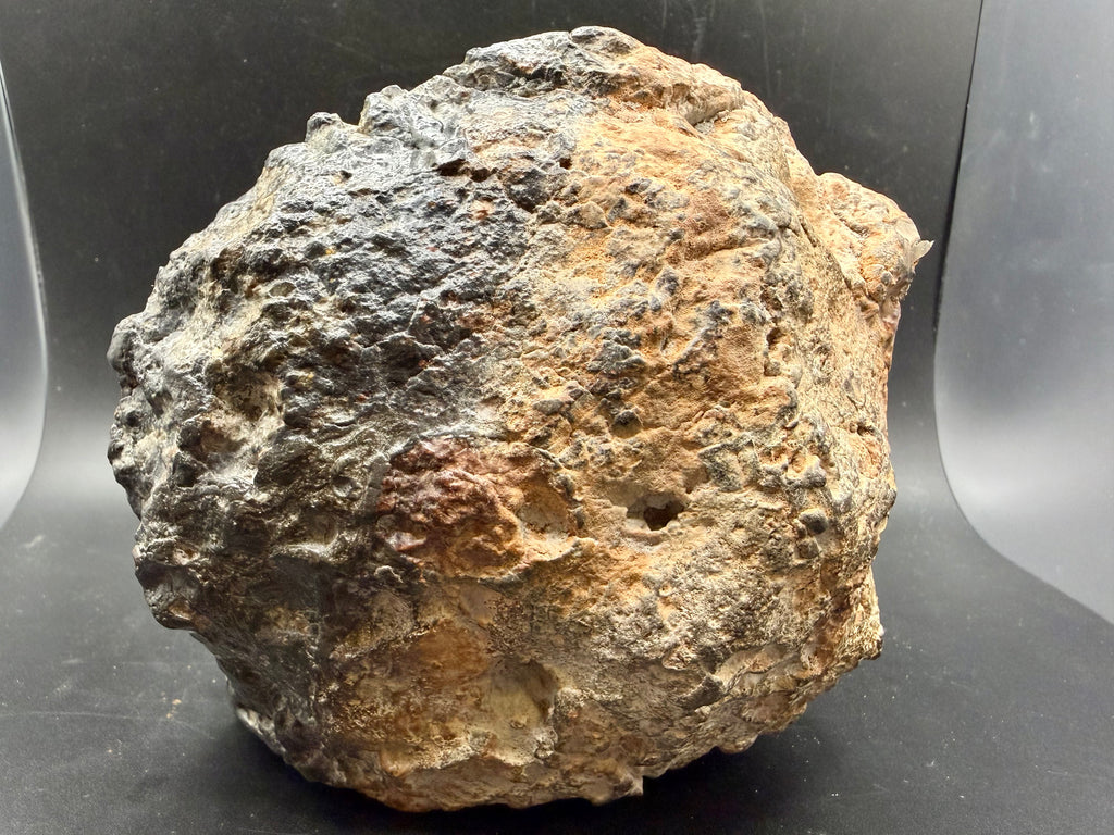 Natural exterior surface of NWA 18048 polymict eucrite meteorite main mass showing weathered desert patina and regmaglypt-like texture