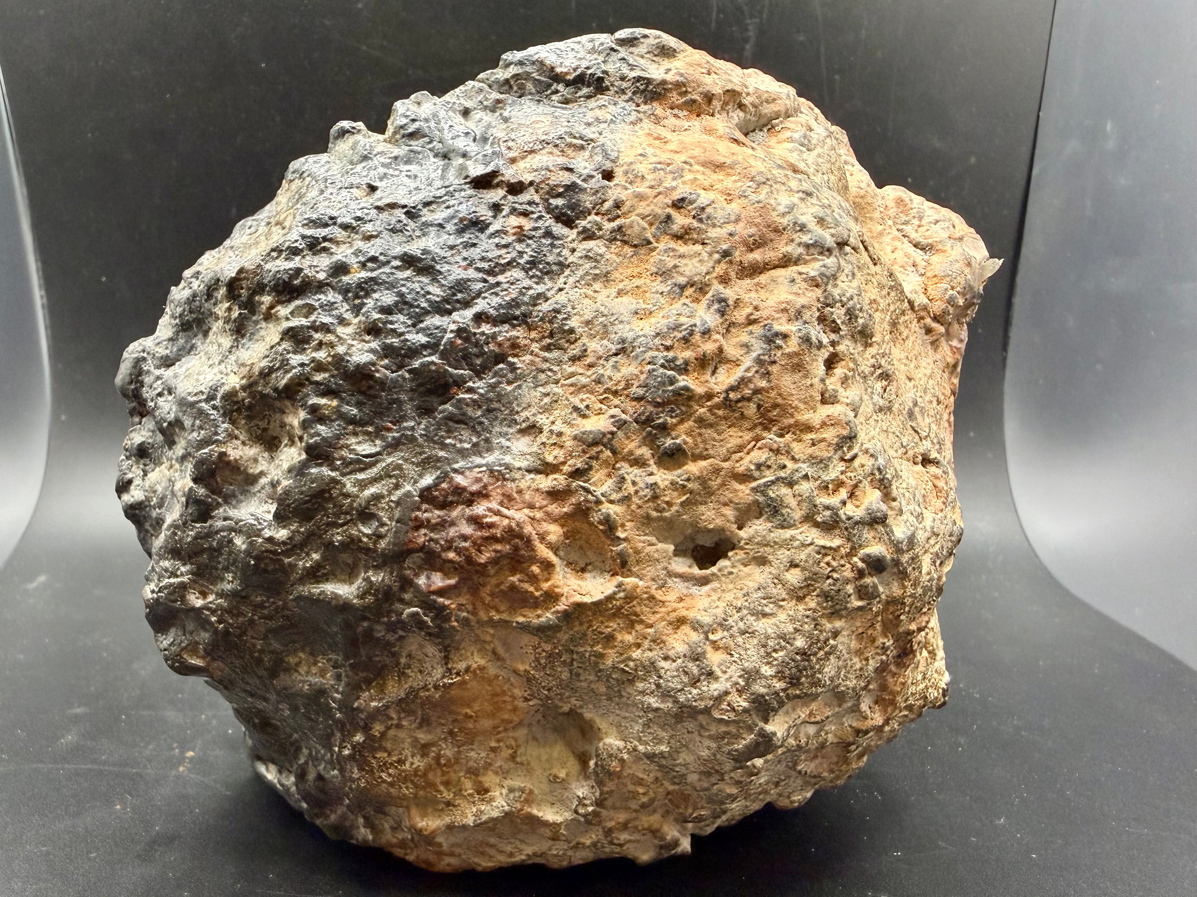 Natural exterior surface of NWA 18048 polymict eucrite meteorite main mass showing weathered desert patina and regmaglypt-like texture