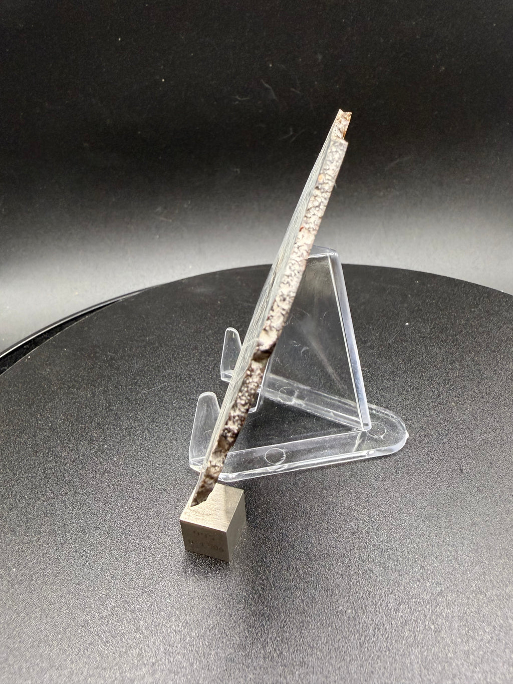 Side profile view of NWA 18448 eucrite full slice showing slice thickness with tungsten cube for scale reference