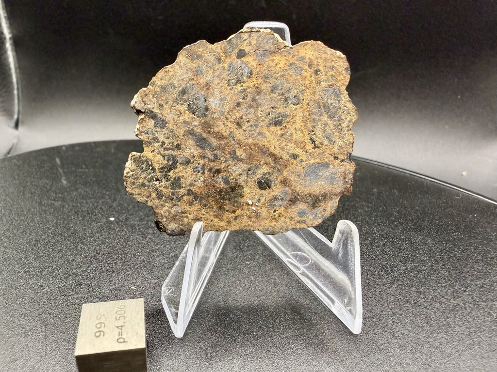 NWA 18591 diogenite meteorite, 6.57g full slice reverse face beside a 1cm scale cube
