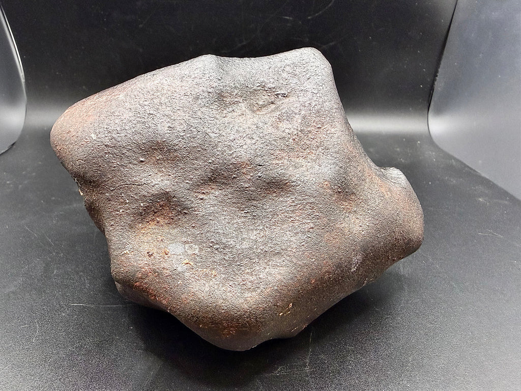 Leading face of oriented NWA ordinary chondrite meteorite showing atmospheric ablation shaping