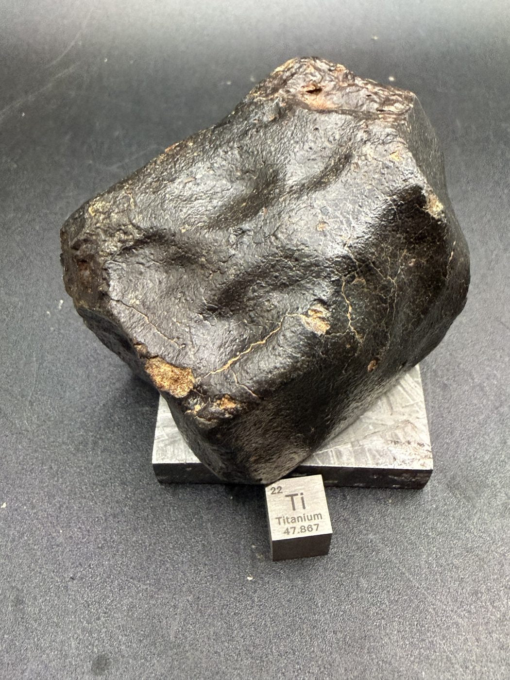 Face with deep regmaglypts in fresh black fusion crust, NWA XXX unclassified ordinary chondrite, 392.28g