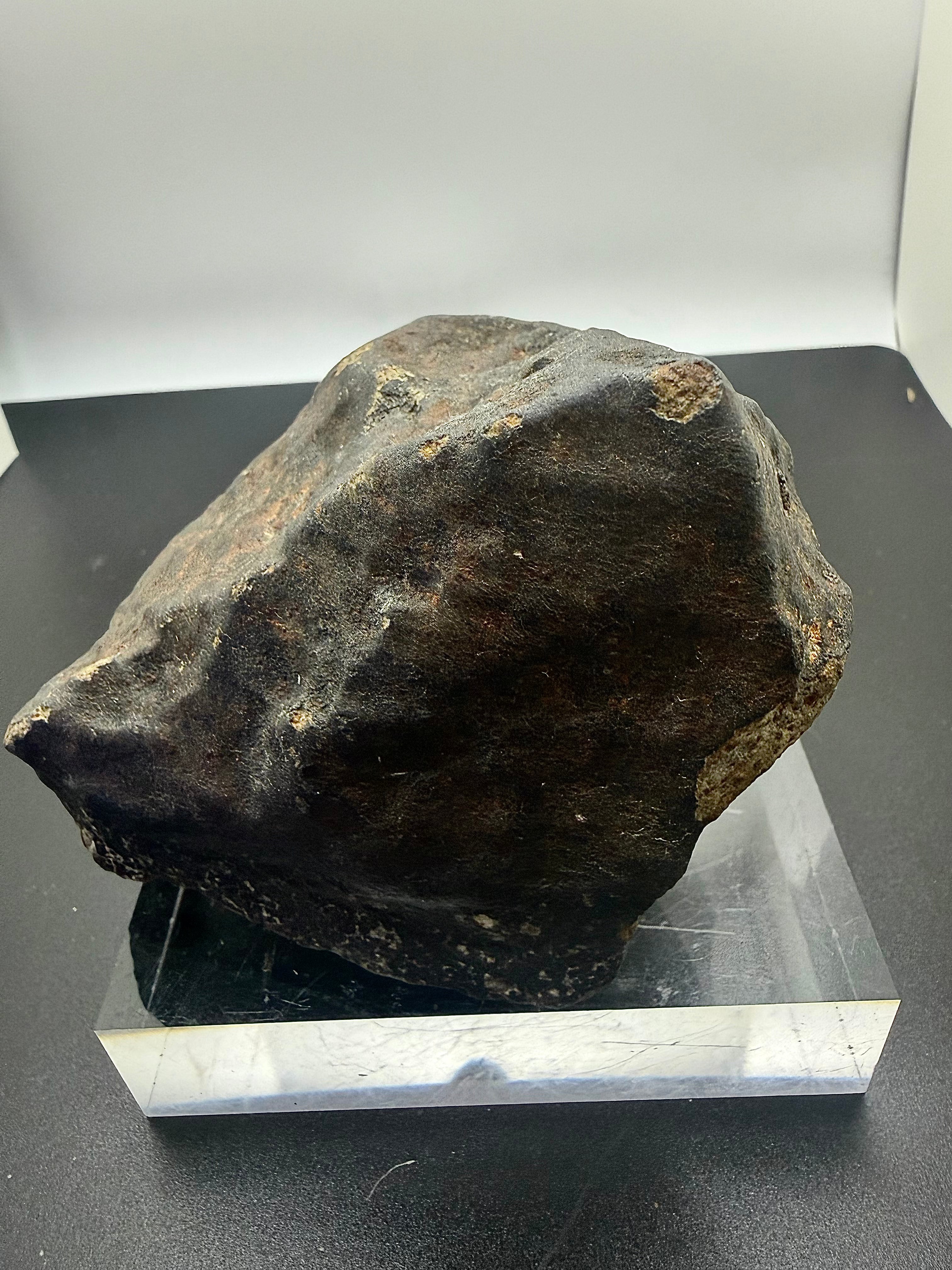Detail view of NWA XXX unclassified ordinary chondrite meteorite showing regmaglypt depressions formed during atmospheric entry, 1091.71g
