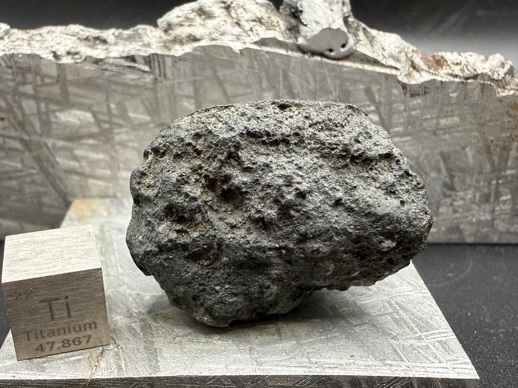 Trailing surface of oriented carbonaceous chondrite meteorite specimen