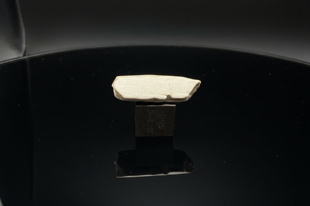 Sebkha el Melah 001 aubrite, 2.51g enstatite crystal in profile on a 1cm titanium scale cube