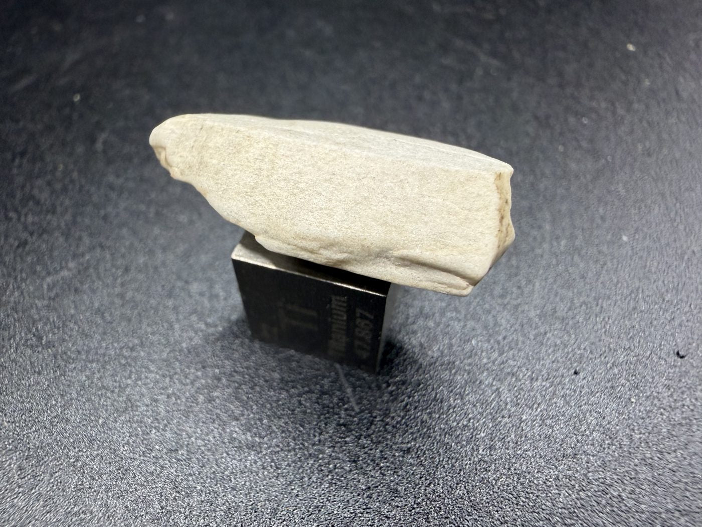 Sebkha el Melah 001 aubrite, 2.51g enstatite crystal top face with cleavage traces