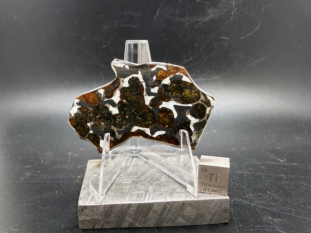 Sericho pallasite meteorite slice 9.33g on acrylic stand, olivine crystals in iron-nickel matrix, stony-iron meteorite, Treasure Coast Meteorite Co.