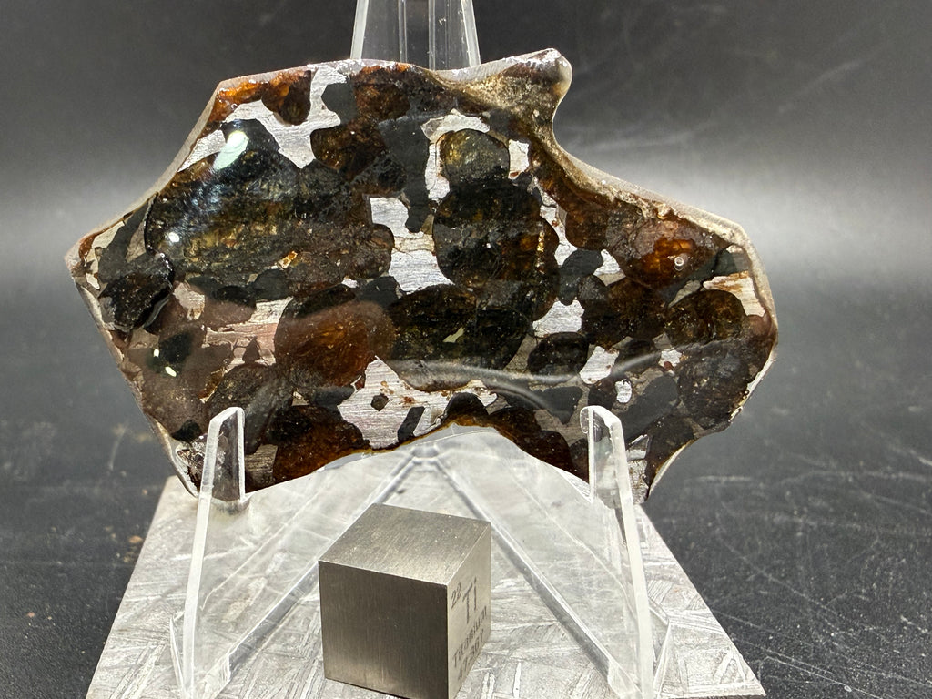 Sericho pallasite meteorite 9.33g, reverse face showing olivine and metal matrix texture, weathered olivine in stony-iron slice